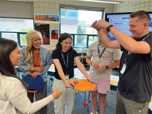 A group of teachers learning a science game for students.
