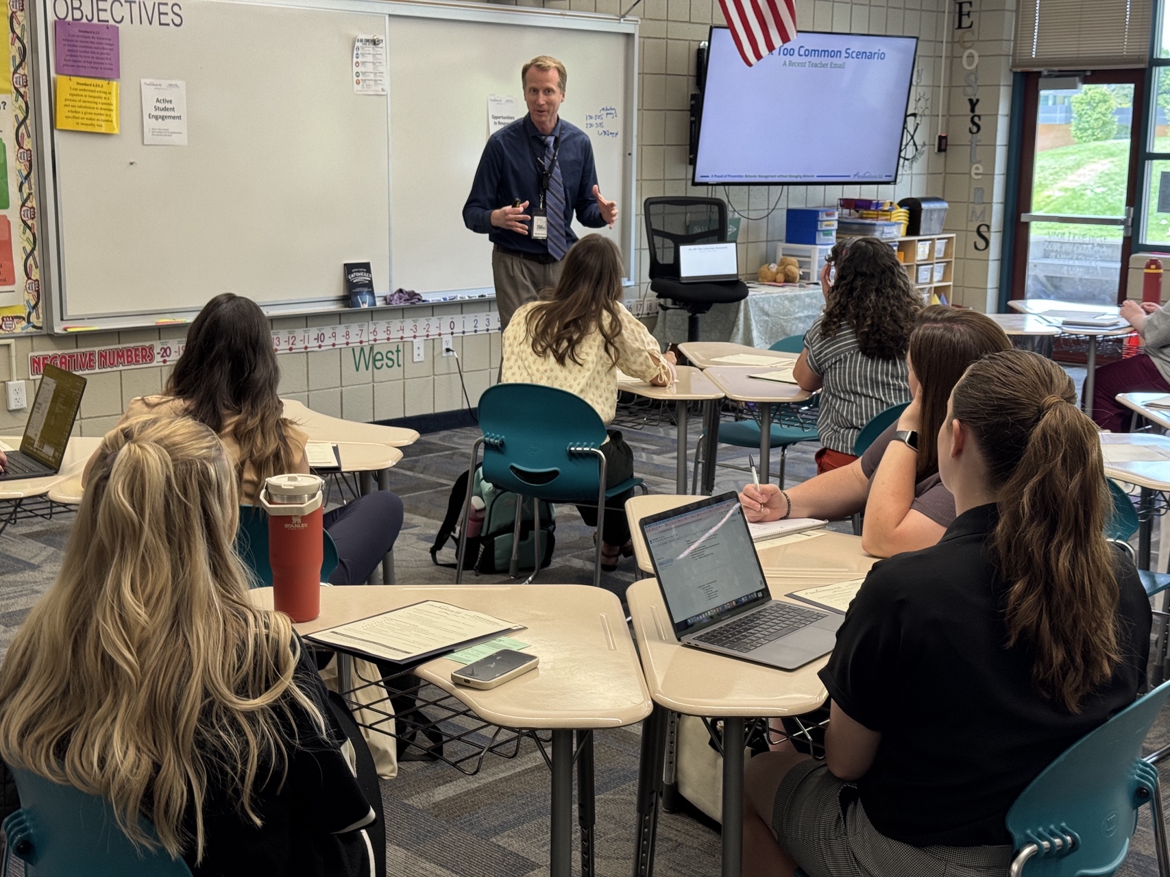 A mentor teacher is teaching a class to other educators who are all engaged. 