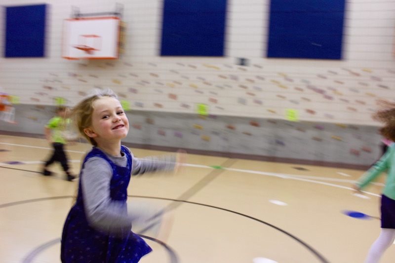 a EBLS student running in the school gym