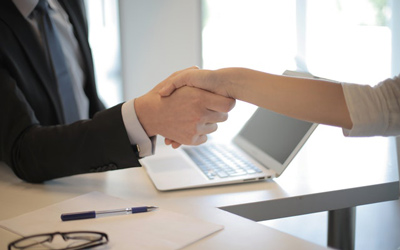 student shaking hands with employer