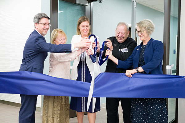 Dean Al Smith; Nursing Department Head Carma Miller; Ellen Rossi, board member of the Emma Eccles Jones Foundation; the Very Reverend Father Frederick Q. Lawson, board member of the Emma Eccles Jones Foundation; and President Elizabeth R. Cantwell cut the ribbon for the new Advanced Nursing Education Suite.