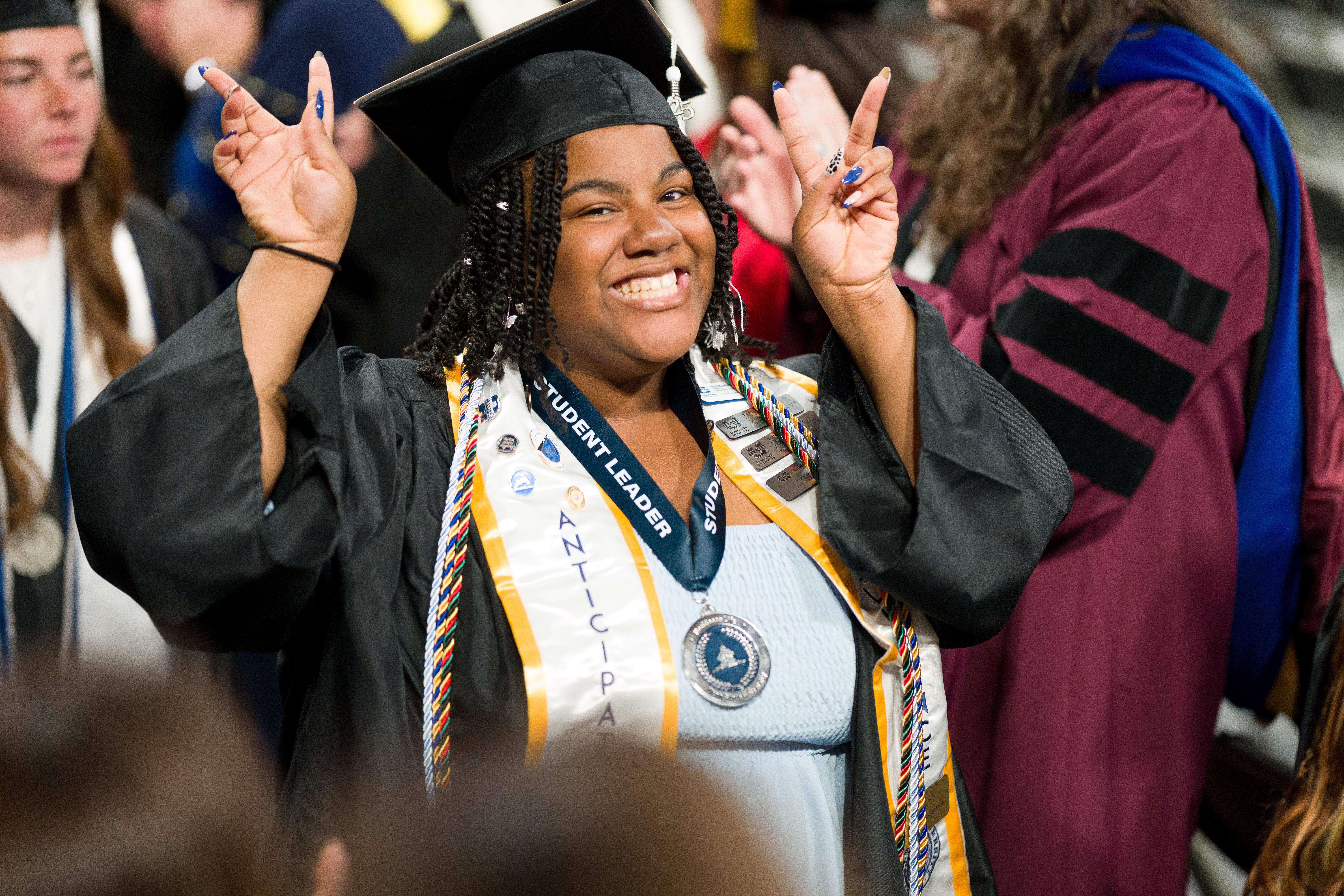 Graduate celebrates in graduation regalia