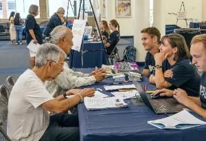 People at booths at Brain Health Fair.
