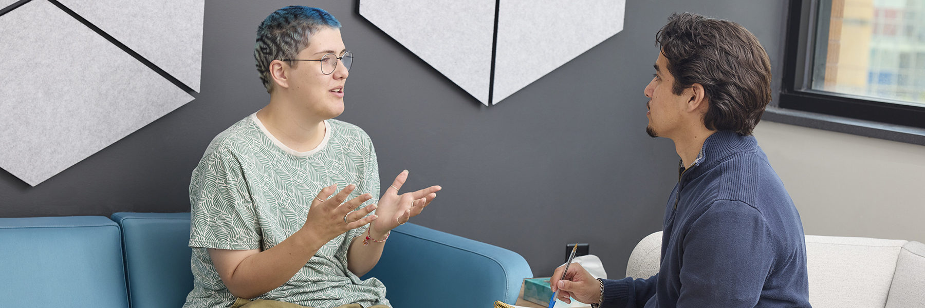 Grad student counselor with a patient in Sorenson room setting.