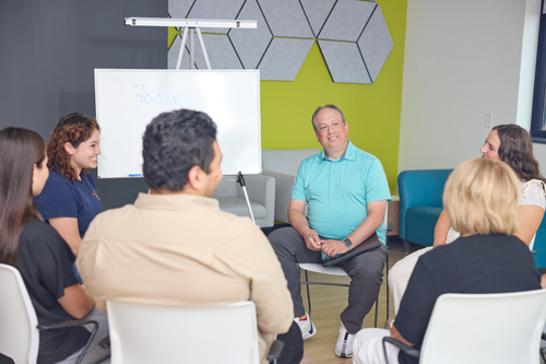 People sitting in a group having discussion.