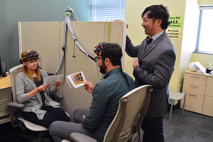 Professor overseeing a brain experiment on two people.