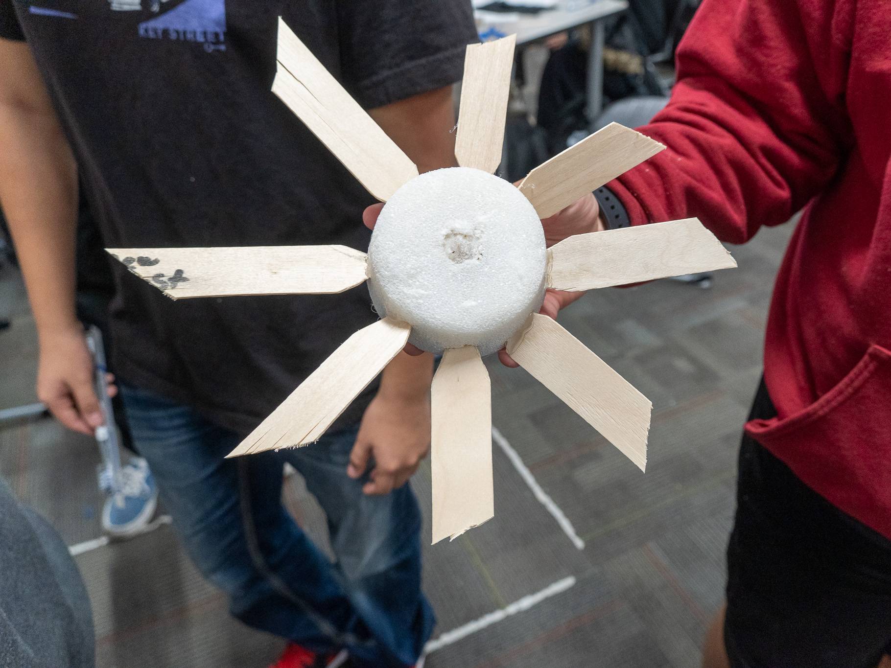 Student holding their wind turbine design